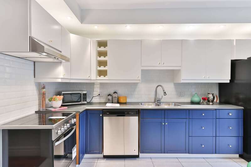 A picture of a grey granite kitchen with blue cabinets